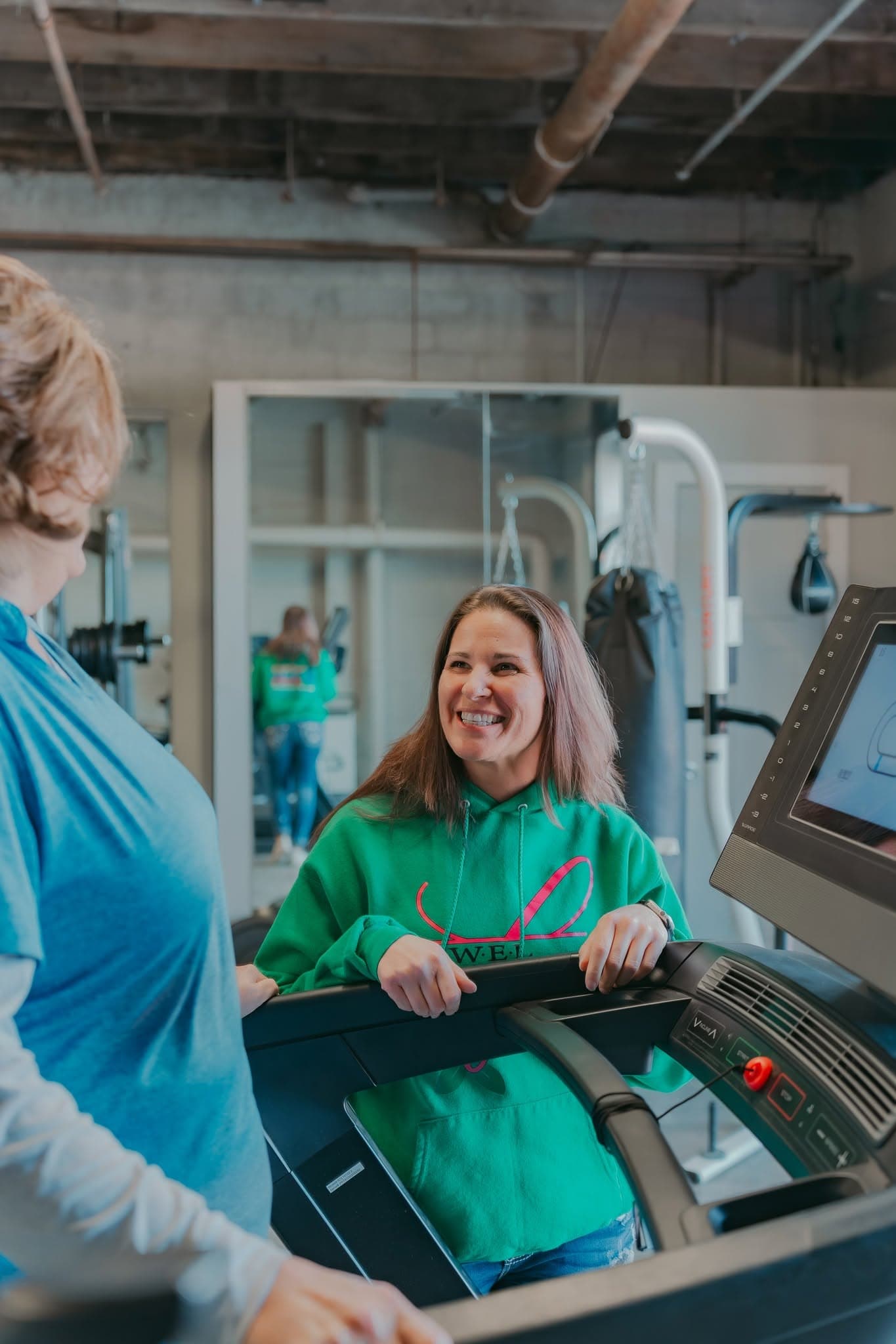 A coach and client in conversation during a treadmill session
