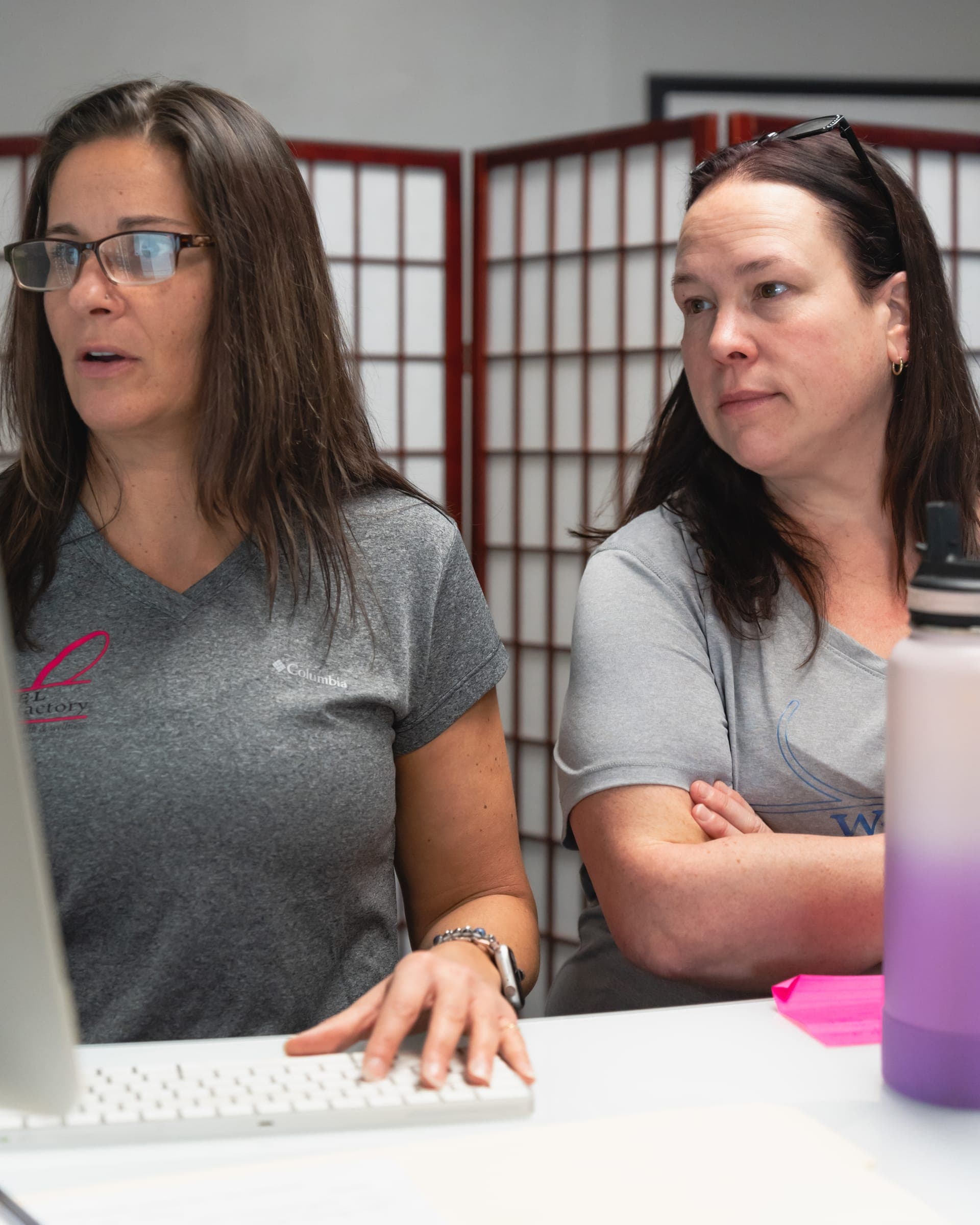 A coach and members working together at The Fitness Factory